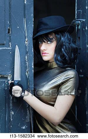 Young woman with a knife in hand View Large Photo Image Picture - Young woman with a knife in hand. Fotosearch