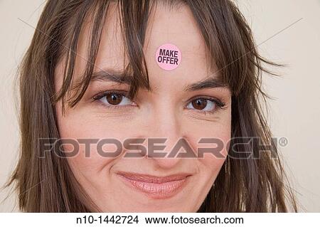 Young woman with a? Make Offer? sticker on her forehead View Large Photo Image Picture - Young woman with a? Make Offer? sticker on her forehead. Fotosearch