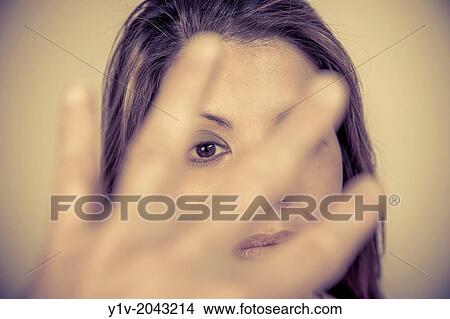 Young woman with a man's hand in front. View Large Photo Image Picture - Young woman with a man's hand in front.. Fotosearch