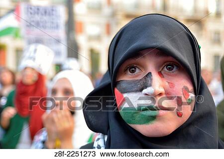 Young woman with a Palestine flag painted on her face protesting against Israeli attacks in the Gaza Strip during a demonstration in Madrid on July 18, 2014. Madrid. Spain. View Large Photo Image Stock Image - Young woman with a Palestine flag painted on her face protesting against Israeli attacks in the Gaza Strip during a demonstration in Madrid on July 18, 2014. Madrid. Spain.. Fotosearch