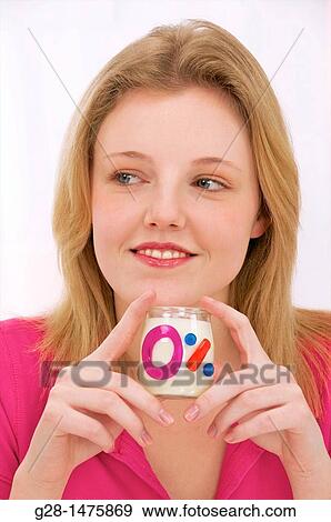 young woman with a zero fat milk yogurt View Large Photo Image Stock Photo - young woman with a zero fat milk yogurt. Fotosearch