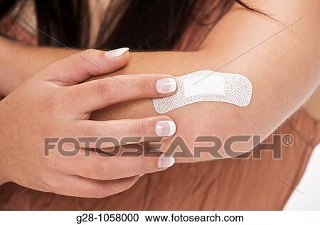 young woman with adhesive sticking on her elbow for a slight wound View Large Photo Image Stock Image - young woman with adhesive sticking on her elbow for a slight wound. Fotosearch