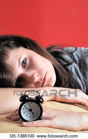 Young woman with an old alarm clock early in the morning View Large Photo Image Stock Image - Young woman with an old alarm clock early in the morning. Fotosearch