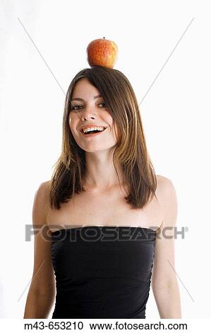Young woman with apple on head View Large Photo Image Stock Image - Young woman with apple on head. Fotosearch