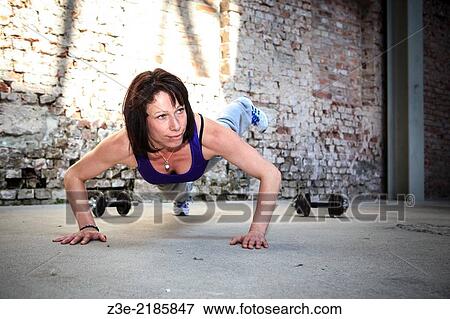 young woman with barbells at fitness exercise in a gym. View Large Photo Image Stock Photo - young woman with barbells at fitness exercise in a gym.. Fotosearch