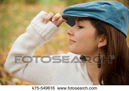 Young woman with blue cap View Large Photo Image Stock Photograph - Young woman with blue cap. Fotosearch