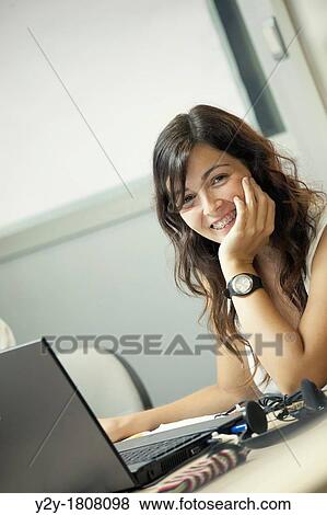 Young woman with dental braces at work View Large Photo Image Stock Photo - Young woman with dental braces at work. Fotosearch