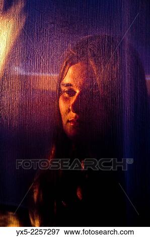 Stock Photo - young woman with face obscured by a cloth.. Fotosearch