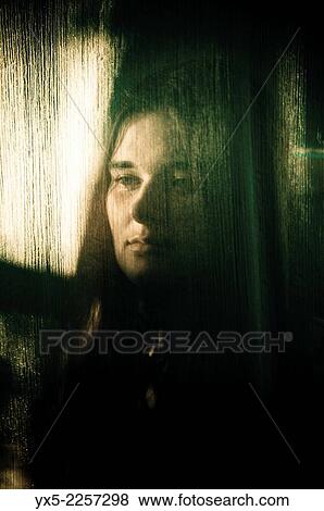 Stock Photo - young woman with face obscured by a cloth.. Fotosearch