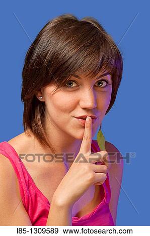 Young woman with finger on lips. View Large Photo Image Stock Photo - Young woman with finger on lips.. Fotosearch