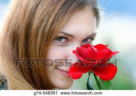 Stock Image - Young woman with flower. Fotosearch