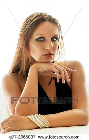 Stock Photo - Young woman with gold bracelet and evening dress. Czech Republic. Prague.. Fotosearch