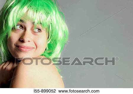 Stock Image - Young woman with green wig. Fotosearch