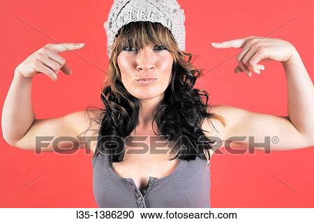 Young woman with hat get up to nonsense View Large Photo Image Stock Image - Young woman with hat get up to nonsense. Fotosearch
