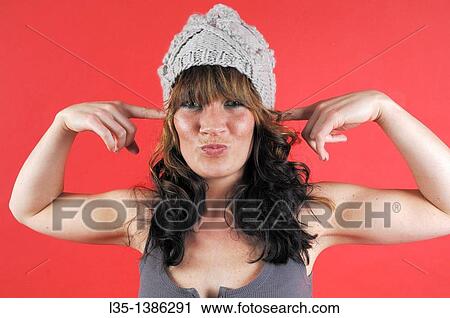 Young woman with hat get up to nonsense View Large Photo Image Stock Image - Young woman with hat get up to nonsense. Fotosearch
