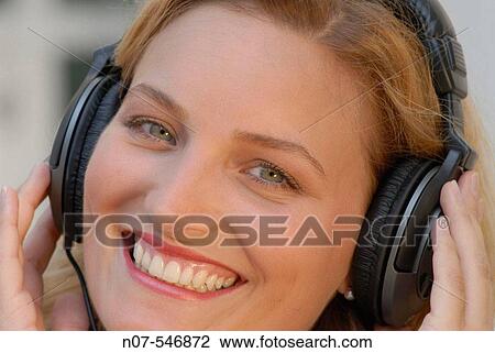 Young woman with headphones enjoying music. View Large Photo Image Stock Image - Young woman with headphones enjoying music.. Fotosearch