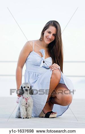Young woman with her pet dog View Large Photo Image Stock Photo - Young woman with her pet dog. Fotosearch