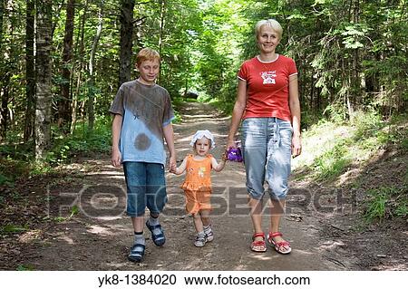 Young Woman With Kids, Family Walking Hand in Hand in Forest View Large Photo Image Stock Image - Young Woman With Kids, Family Walking Hand in Hand in Forest. Fotosearch