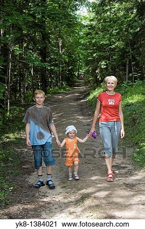 Young Woman With Kids, Family Walking Hand in Hand in Forest View Large Photo Image Stock Image - Young Woman With Kids, Family Walking Hand in Hand in Forest. Fotosearch