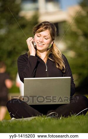 Young woman with laptop computer and cell phone - Vancouver, British Columbia, Canada View Large Photo Image Stock Image - Young woman with laptop computer and cell phone - Vancouver, British Columbia, Canada. Fotosearch