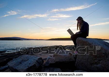 Young woman with laptop computer on rocky beach Acadia National Park, Schoodic Peninsula, Maine, USA View Large Photo Image Stock Photo - Young woman with laptop computer on rocky beach Acadia National Park, Schoodic Peninsula, Maine, USA. Fotosearch