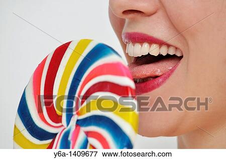 Stock Photo - Young woman with lollipop. Fotosearch