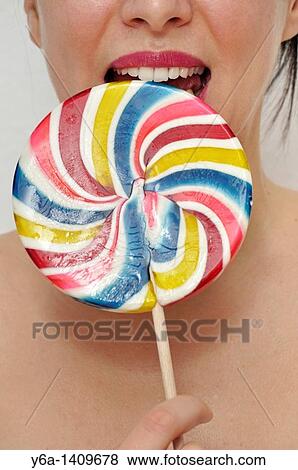 Young woman with lollipop View Large Photo Image Stock Photo - Young woman with lollipop. Fotosearch