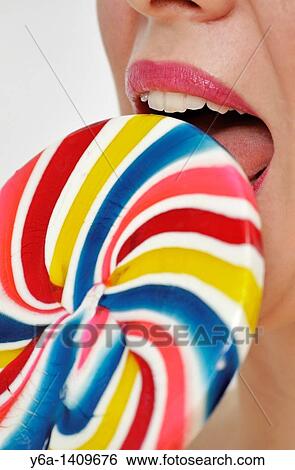 Stock Photograph - Young woman with lollipop. Fotosearch