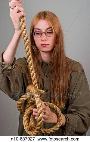 Young woman, with long red hair and glasses, making knots in a thick rope. View Large Photo Image Stock Photo - Young woman, with long red hair and glasses, making knots in a thick rope.. Fotosearch