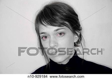 Picture - Young woman with red eyes. Fotosearch