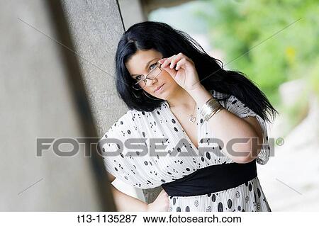 Young woman with spectacles is watching View Large Photo Image Stock Photo - Young woman with spectacles is watching. Fotosearch