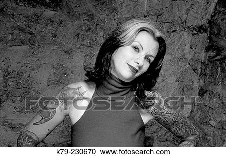 Stock Image - Young woman with tatoos.. Fotosearch