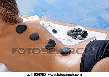 Young woman with therapeutic hot stones on her back There are more stones in the background out of focus View Large Photo Image Stock Image - Young woman with therapeutic hot stones on her back There are more stones in the background out of focus. Fotosearch