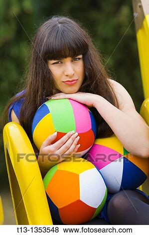 Young woman with three balls atop Yellow slide View Large Photo Image Stock Photo - Young woman with three balls atop Yellow slide. Fotosearch