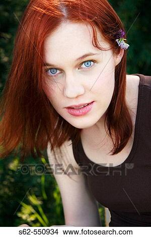 Picture - Young Woman with Wildflower Behind Ear. Fotosearch