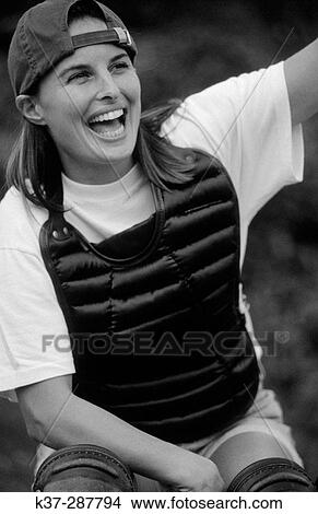 Young woman with winning smile and star quality playing in baseball game View Large Photo Image Picture - Young woman with winning smile and star quality playing in baseball game. Fotosearch