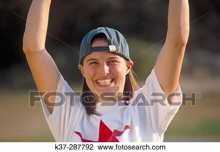 Young woman with winning smile and star quality playing in baseball game View Large Photo Image Stock Image - Young woman with winning smile and star quality playing in baseball game. Fotosearch