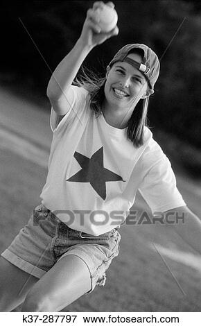 Young woman with winning smile and star quality playing in baseball game View Large Photo Image Stock Photo - Young woman with winning smile and star quality playing in baseball game. Fotosearch