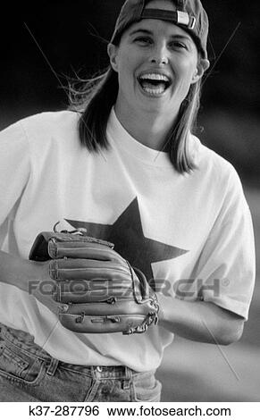Young woman with winning smile and star quality playing in baseball game View Large Photo Image Stock Photograph - Young woman with winning smile and star quality playing in baseball game. Fotosearch
