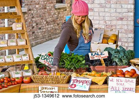 Young woman working at farmer's market, Nevada City, California View Large Photo Image Stock Image - Young woman working at farmer's market, Nevada City, California. Fotosearch