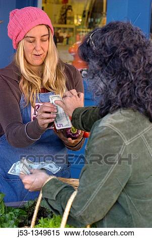Young woman working at farmer's market, Nevada City, California View Large Photo Image Stock Photography - Young woman working at farmer's market, Nevada City, California. Fotosearch