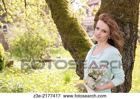 young woman working in the garden, Coburg, Germany. View Large Photo Image Stock Photo - young woman working in the garden, Coburg, Germany.. Fotosearch