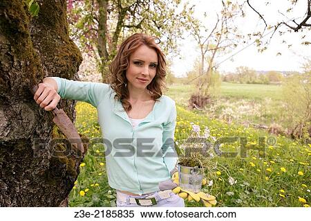 young woman working in the garden, Coburg, Germany. View Large Photo Image Stock Photography - young woman working in the garden, Coburg, Germany.. Fotosearch