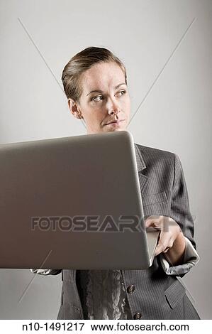 Young woman working on her laptop computer View Large Photo Image Stock Photo - Young woman working on her laptop computer. Fotosearch