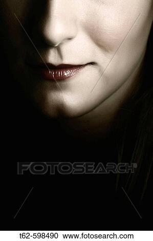 Stock Image - Young woman's face. Smile detail.. Fotosearch