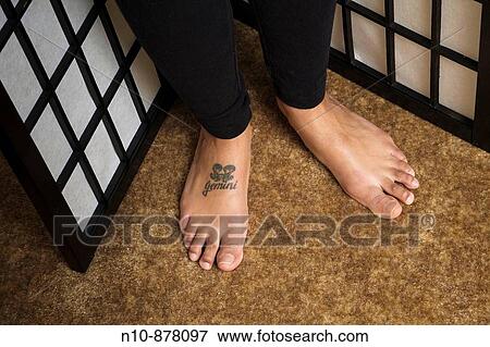 Young woman's feet with? Gemini? tattooed on one foot. View Large Photo Image Stock Photo - Young woman's feet with? Gemini? tattooed on one foot.. Fotosearch