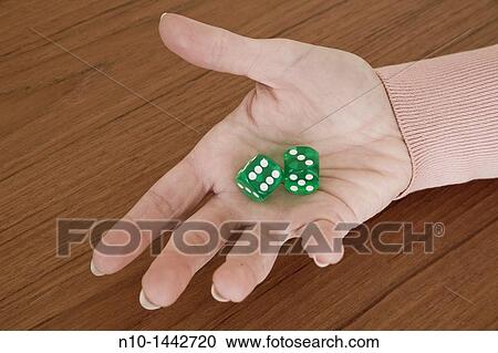 Young woman's hand holding a pair of green dice View Large Photo Image Stock Image - Young woman's hand holding a pair of green dice. Fotosearch