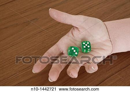 Young woman's hand holding a pair of green dice View Large Photo Image Stock Image - Young woman's hand holding a pair of green dice. Fotosearch