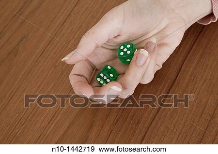 Young woman's hand holding a pair of green dice View Large Photo Image Stock Photo - Young woman's hand holding a pair of green dice. Fotosearch