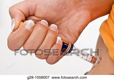 young woman's hand injecting insulin against diabetes close up View Large Photo Image Stock Photo - young woman's hand injecting insulin against diabetes close up. Fotosearch